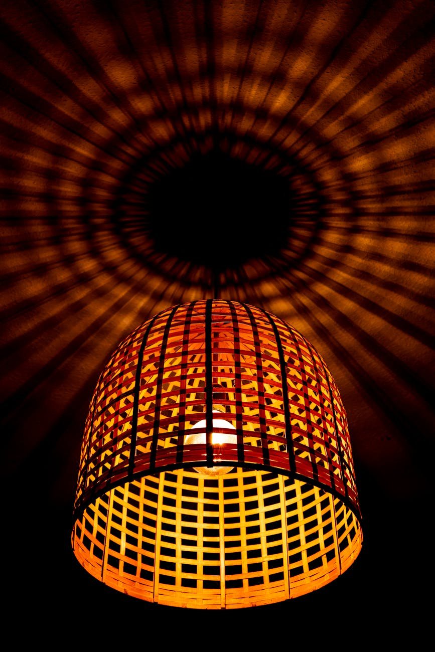 warm rattan basket light casting shadows